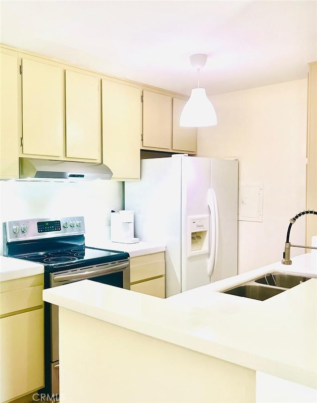 23515 Lyons Ave Unit 232, Valencia, CA 91355 - kitchen with electric stove, white refrigerator with ice dispenser, cream cabinetry, under cabinet range hood, and light countertops