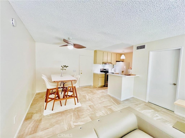 23515 Lyons Ave Unit 232, Valencia, CA 91355 - kitchen featuring stainless steel range with electric cooktop, white fridge with ice dispenser, a textured ceiling, light countertops, and a ceiling fan