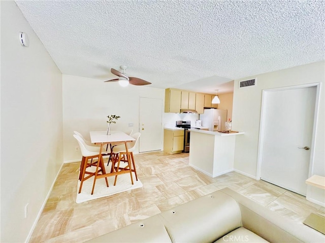 23515 Lyons Ave Unit 232, Valencia, CA 91355 - kitchen featuring stainless steel electric range, white refrigerator with ice dispenser, a textured ceiling, light countertops, and ceiling fan