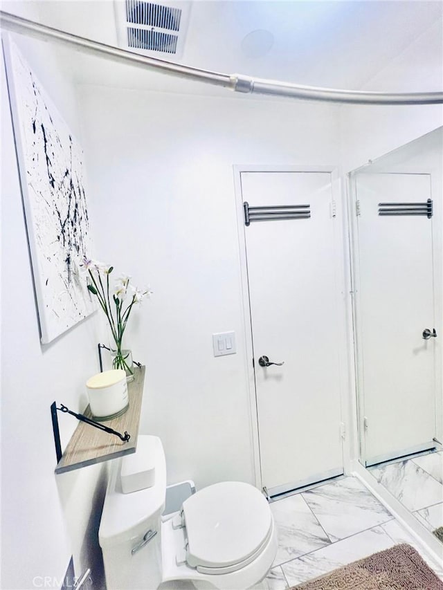 23515 Lyons Ave Unit 232, Valencia, CA 91355 - bathroom featuring toilet and marble look tiles