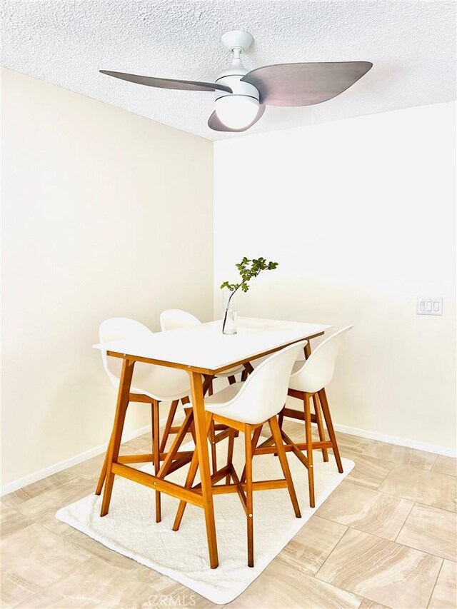 23515 Lyons Ave Unit 232, Valencia, CA 91355 - dining space featuring a textured ceiling and a ceiling fan