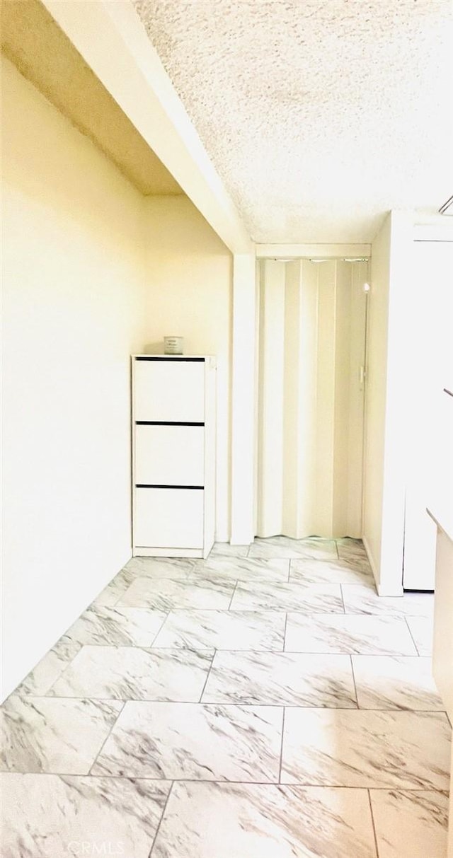 23515 Lyons Ave Unit 232, Valencia, CA 91355 - spare room with a textured ceiling and light marble finish flooring