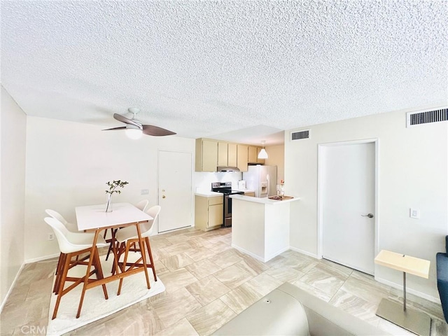 23515 Lyons Ave Unit 232, Valencia, CA 91355 - kitchen with white fridge with ice dispenser, stainless steel range with electric cooktop, a textured ceiling, light countertops, and a ceiling fan