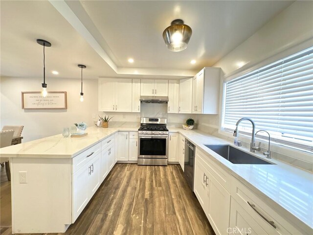 4723 La Villa Marina Unit F, Marina Del Rey, CA 90292 - kitchen with stainless steel gas range oven, a peninsula, dark wood-style flooring, recessed lighting, and white cabinetry