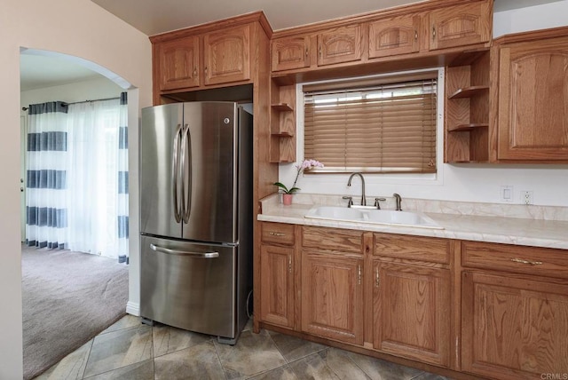 522 Garfield St, Oceanside, CA 92054 - kitchen featuring freestanding refrigerator, arched walkways, open shelves, and brown cabinets