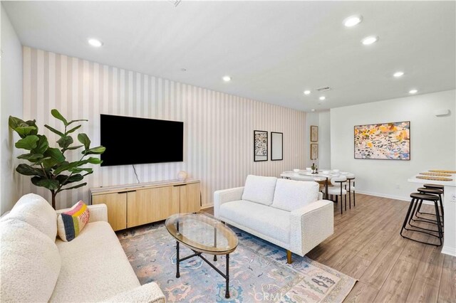 3957 E Huntington St, Ontario, CA 91761 - living area with recessed lighting, wallpapered walls, wood finished floors, and an accent wall