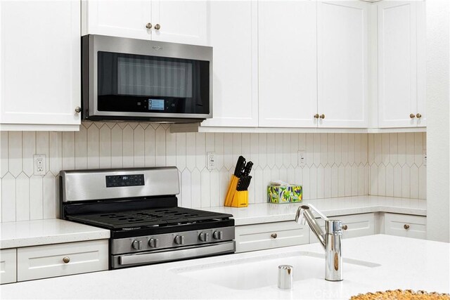 3957 E Huntington St, Ontario, CA 91761 - kitchen with appliances with stainless steel finishes, white cabinets, and tasteful backsplash