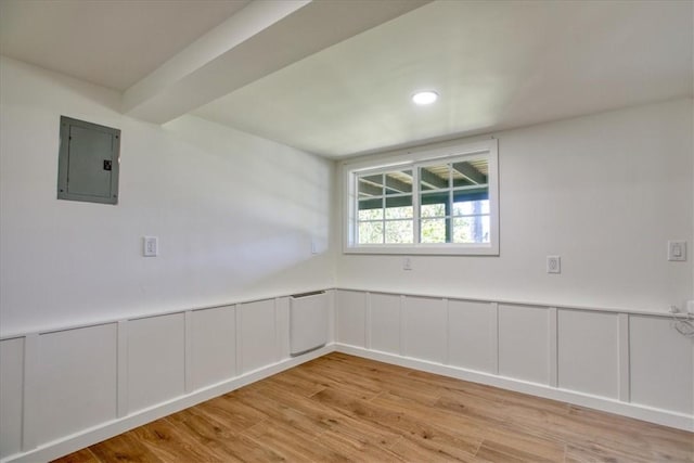 2103 Benson Ave, Cambria, CA 93428 - unfurnished room with electric panel, light wood-style flooring, a decorative wall, a wainscoted wall, and recessed lighting