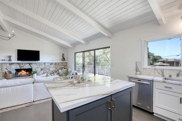2103 Benson Ave, Cambria, CA 93428 - kitchen with dishwasher, a kitchen island, light stone countertops, and a stone fireplace