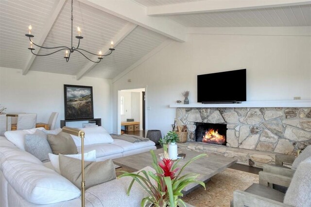 2103 Benson Ave, Cambria, CA 93428 - living area with a chandelier, a stone fireplace, and wood finished floors