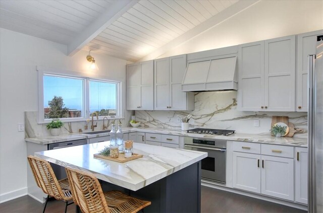2103 Benson Ave, Cambria, CA 93428 - kitchen with appliances with stainless steel finishes, custom exhaust hood, a kitchen breakfast bar, backsplash, and wooden ceiling
