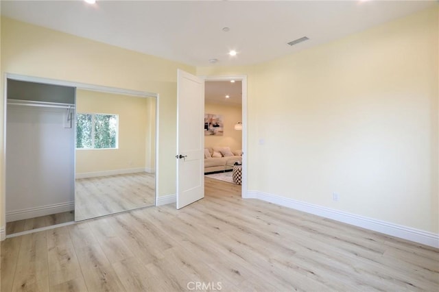 3264 E Holt Ave, West Covina, CA 91791 - unfurnished bedroom featuring light wood-style flooring, a closet, and recessed lighting