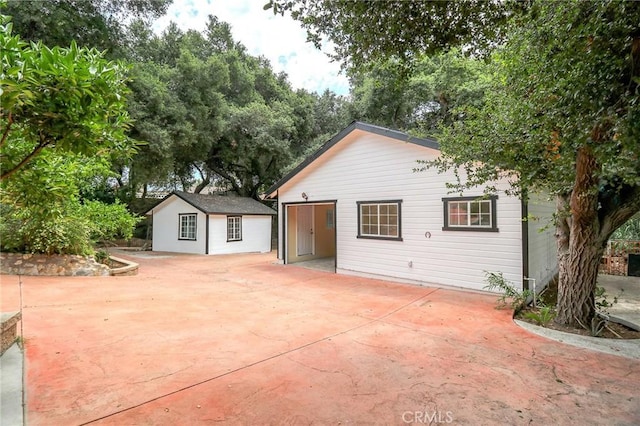 3264 E Holt Ave, West Covina, CA 91791 - rear view of property with an outdoor structure and a patio
