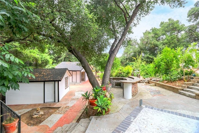 3264 E Holt Ave, West Covina, CA 91791 - view of patio / terrace featuring a fire pit and a shed
