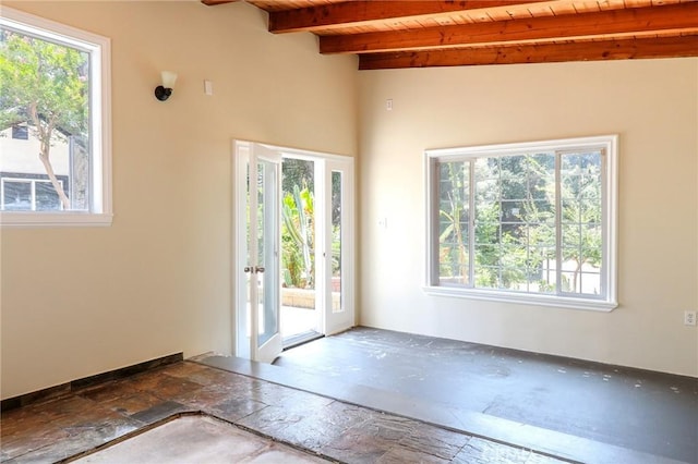 3264 E Holt Ave, West Covina, CA 91791 - spare room with a wooden ceiling with exposed beams, healthy amount of natural light, and stone finish flooring