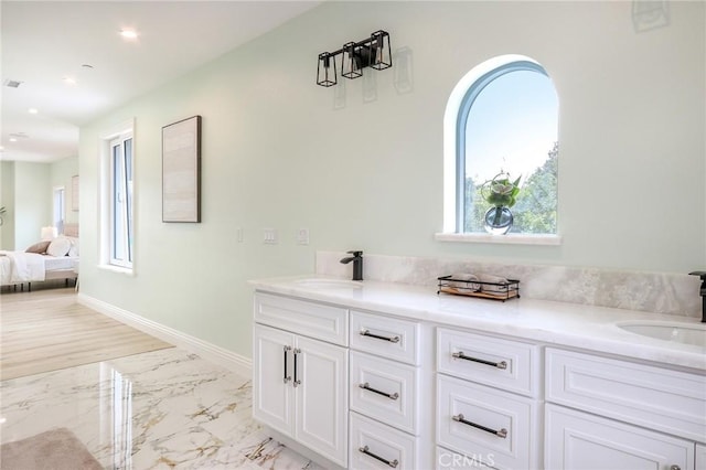 3264 E Holt Ave, West Covina, CA 91791 - ensuite bathroom featuring plenty of natural light, double vanity, marble look tile flooring, and recessed lighting