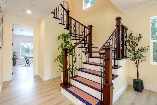3264 E Holt Ave, West Covina, CA 91791 - staircase featuring wood finished floors, plenty of natural light, and crown molding