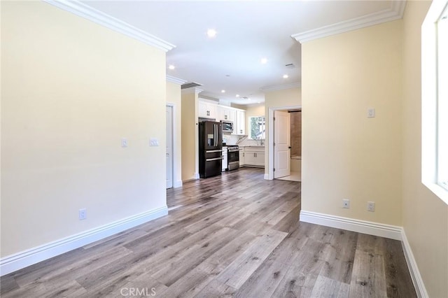 3264 E Holt Ave, West Covina, CA 91791 - unfurnished living room featuring ornamental molding, recessed lighting, and light wood-type flooring