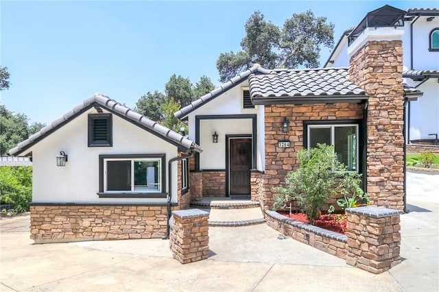 3264 E Holt Ave, West Covina, CA 91791 - view of front facade with stone siding, a tile roof, and stucco siding