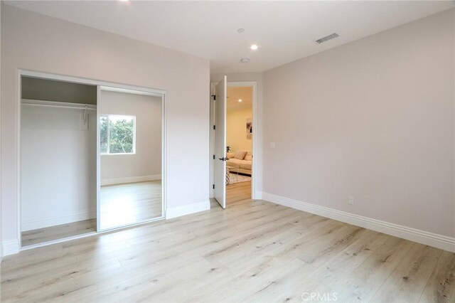 3264 E Holt Ave, West Covina, CA 91791 - unfurnished bedroom featuring light wood finished floors, a closet, and recessed lighting