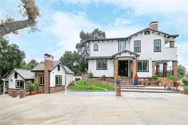 3264 E Holt Ave, West Covina, CA 91791 - mediterranean / spanish-style home with a chimney, stucco siding, and stone siding
