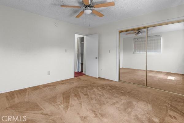 3014 E 3rd St, Los Angeles, CA 90033 - unfurnished bedroom with carpet flooring, a textured ceiling, a closet, and ceiling fan