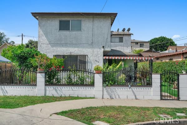 3014 E 3rd St, Los Angeles, CA 90033 - view of front of property featuring a fenced front yard, stucco siding, and a gate