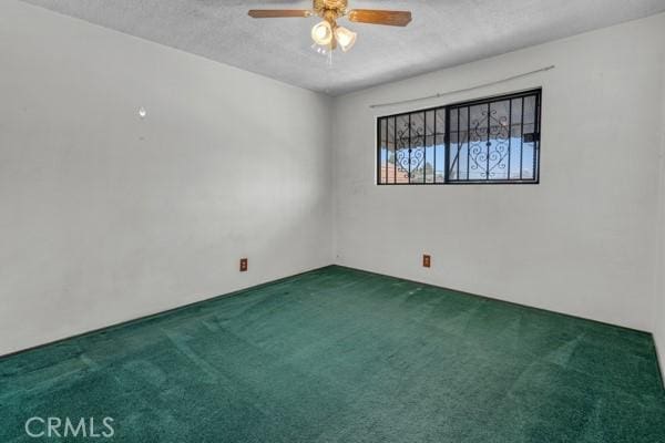 3014 E 3rd St, Los Angeles, CA 90033 - spare room featuring carpet, a ceiling fan, and a textured ceiling