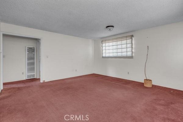 3014 E 3rd St, Los Angeles, CA 90033 - carpeted empty room with a textured ceiling and a heating unit