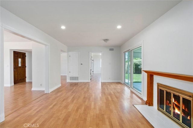 2458 W Marian Ave, Anaheim, CA 92804 - unfurnished living room featuring light wood-type flooring, a glass covered fireplace, and recessed lighting