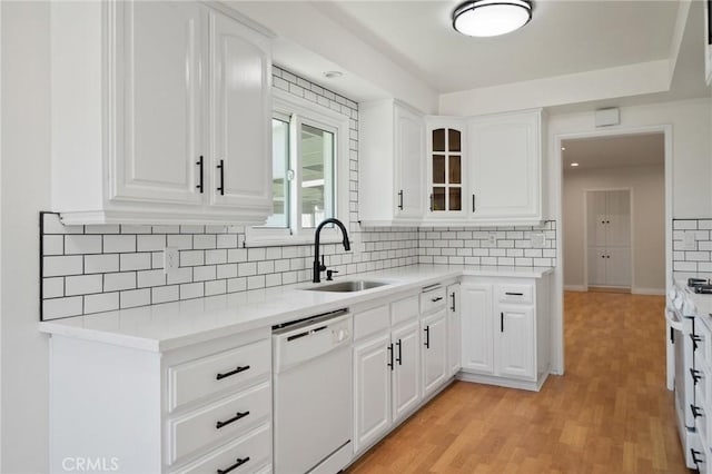 2458 W Marian Ave, Anaheim, CA 92804 - kitchen featuring white appliances, light countertops, glass insert cabinets, and tasteful backsplash