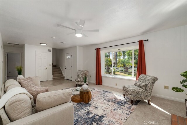 2041 Caballeros Rd, Norco, CA 92860 - living room with stairway, ceiling fan, and light carpet