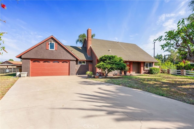 2041 Caballeros Rd, Norco, CA 92860 - view of front of house with driveway, a garage, stucco siding, and a chimney