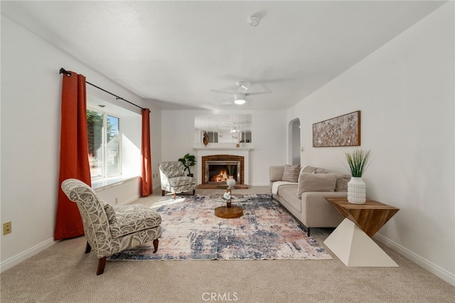 2041 Caballeros Rd, Norco, CA 92860 - carpeted living room with a fireplace, arched walkways, and ceiling fan