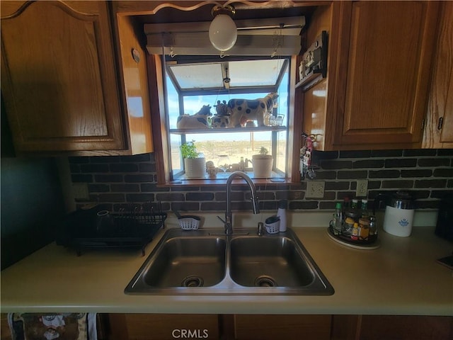 5566 Oleta Rd, Landers, CA 92285 - kitchen with tasteful backsplash, light countertops, and brown cabinetry