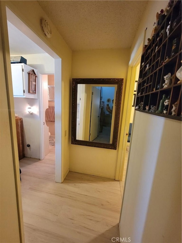 5566 Oleta Rd, Landers, CA 92285 - corridor featuring light wood-style flooring and a textured ceiling