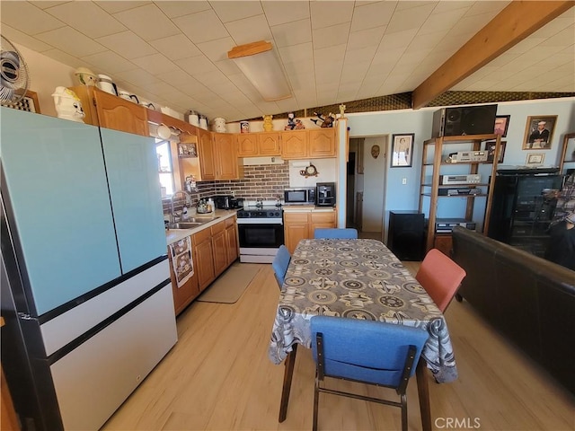 5566 Oleta Rd, Landers, CA 92285 - kitchen featuring freestanding refrigerator, electric range, stainless steel microwave, light wood-style floors, and light countertops