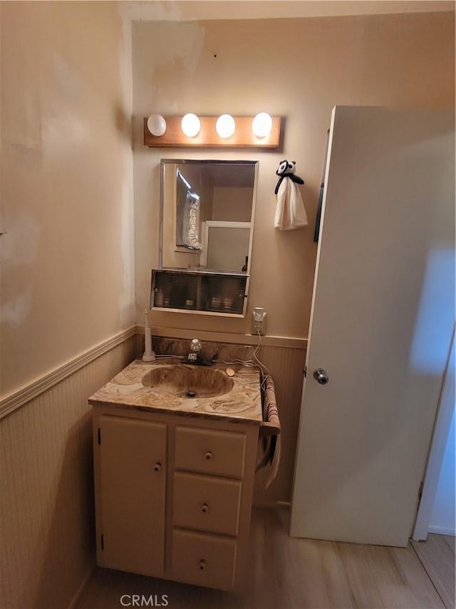 5566 Oleta Rd, Landers, CA 92285 - bathroom with wainscoting, vanity, and wood finished floors
