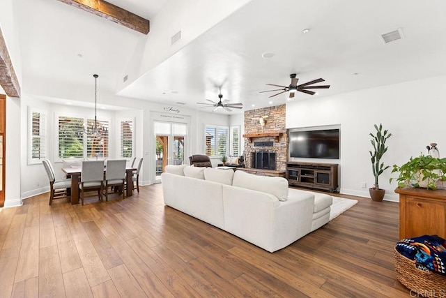 10166 Rancho Roble Rd, Escondido, CA 92026 - living area featuring a stone fireplace, wood-type flooring, a ceiling fan, and beam ceiling