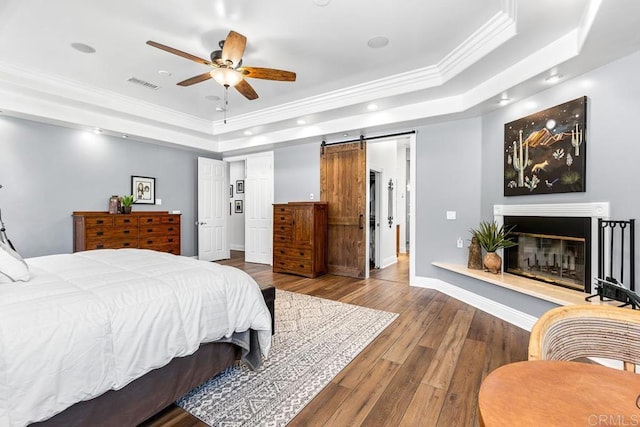10166 Rancho Roble Rd, Escondido, CA 92026 - bedroom featuring a raised ceiling, crown molding, recessed lighting, wood finished floors, and a glass covered fireplace