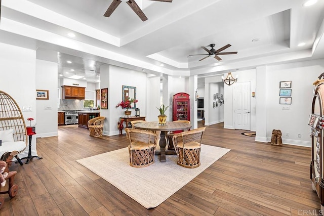10166 Rancho Roble Rd, Escondido, CA 92026 - dining area featuring ceiling fan, a tray ceiling, dark wood-style floors, recessed lighting, and a chandelier