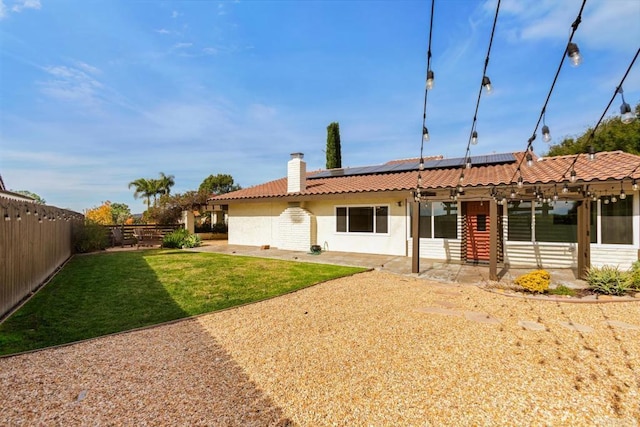 13837 Tam O Shanter Ct, Poway, CA 92064 - back of property with a fenced backyard, a tile roof, roof mounted solar panels, a patio area, and a chimney