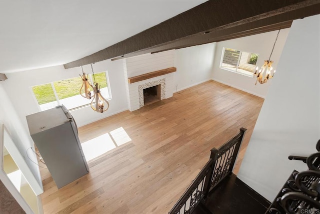 13837 Tam O Shanter Ct, Poway, CA 92064 - living area with a chandelier, wood finished floors, a tiled fireplace, and beam ceiling