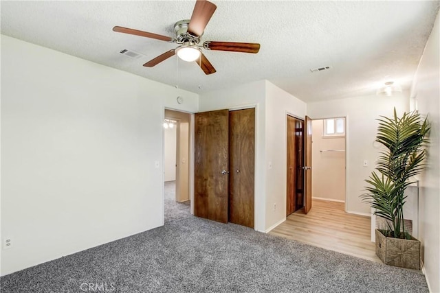 1593 W Carter St, Bloomington, CA 92316 - unfurnished bedroom with carpet floors, a textured ceiling, and a ceiling fan