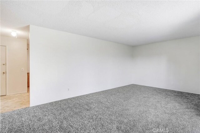 1593 W Carter St, Bloomington, CA 92316 - spare room with light colored carpet and a textured ceiling