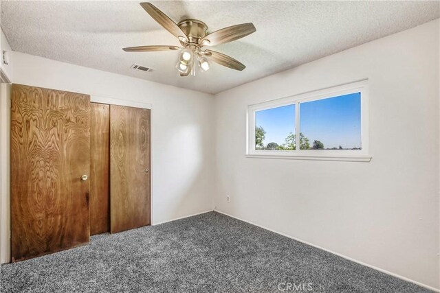1593 W Carter St, Bloomington, CA 92316 - unfurnished bedroom featuring carpet floors, a textured ceiling, a ceiling fan, and a closet