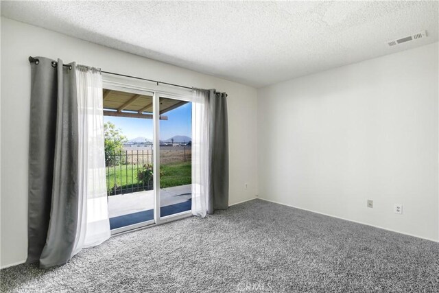 1593 W Carter St, Bloomington, CA 92316 - carpeted empty room with a textured ceiling