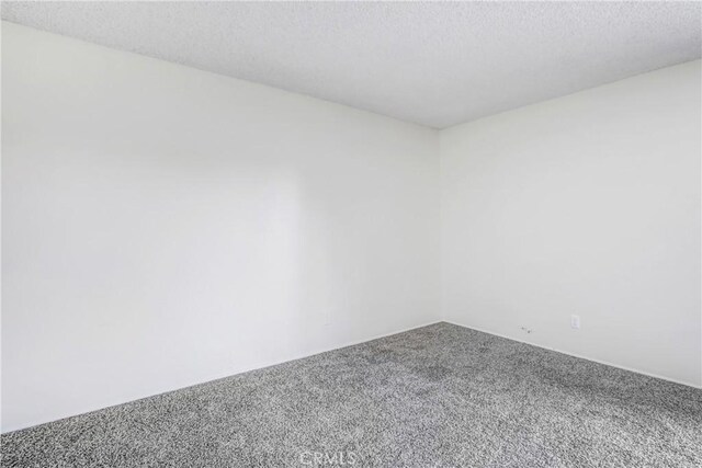 1593 W Carter St, Bloomington, CA 92316 - empty room with carpet flooring and a textured ceiling