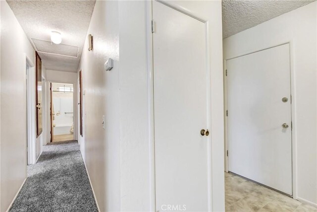 1593 W Carter St, Bloomington, CA 92316 - corridor featuring a textured ceiling and baseboards