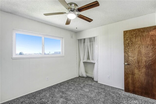1593 W Carter St, Bloomington, CA 92316 - unfurnished bedroom with carpet, a textured ceiling, and ceiling fan